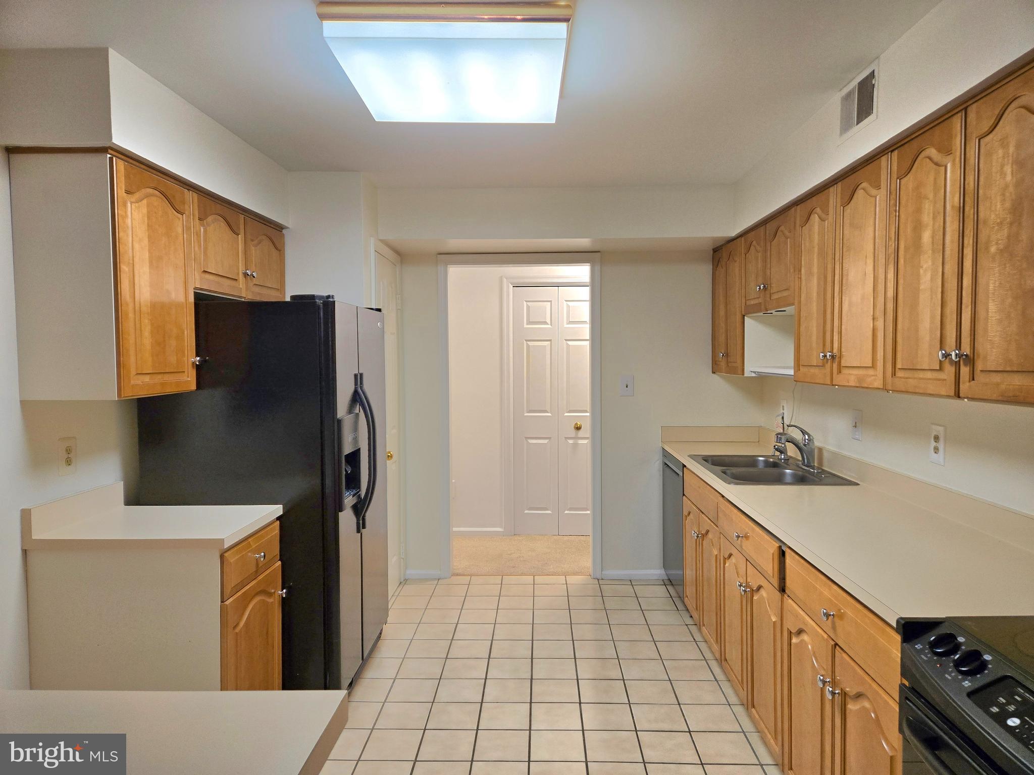1537 Church Hill Place, Unit 1537 Reston, VA 20194 - Photo 6 of 40 a kitchen with stainless steel appliances granite countertop a refrigerator a stove and a sink