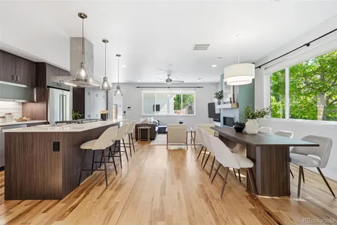 a large kitchen with a table and chairs