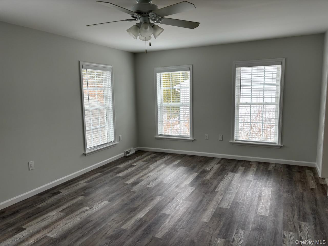 1661 Old Country Road, Unit 539 Riverhead, NY 11901 - Photo 13 of 26 a view of an empty room with wooden floor and a window