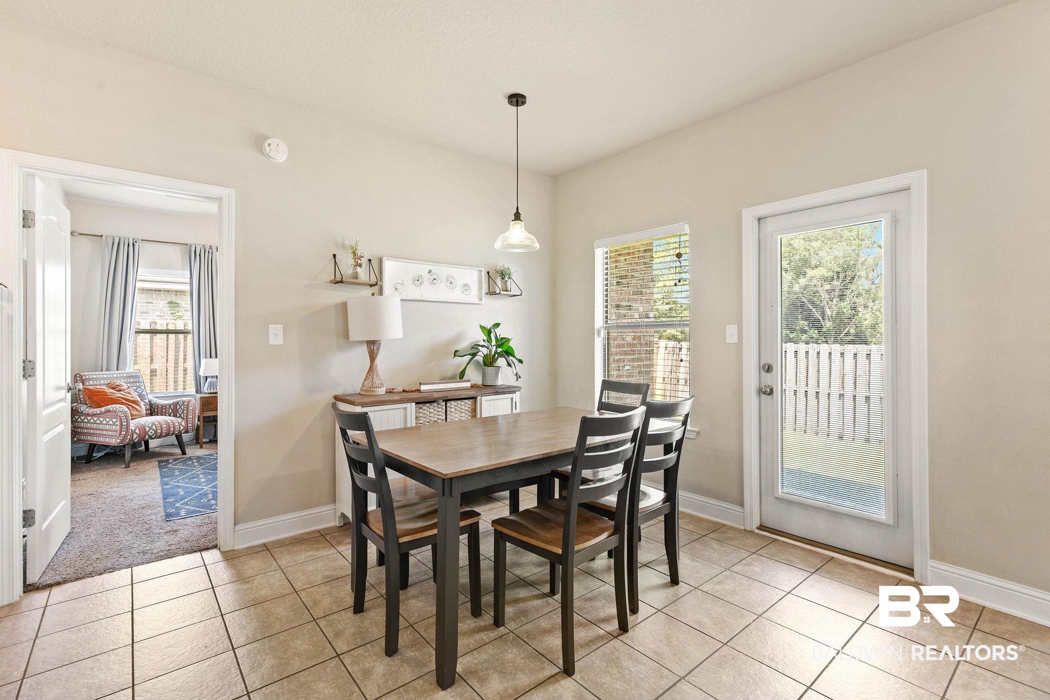 2216 Livingstone Court Mobile, AL 36695 - Photo 9 of 62 Dining area featuring tile flooring, a window with blinds, and a glass-paneled exterior door