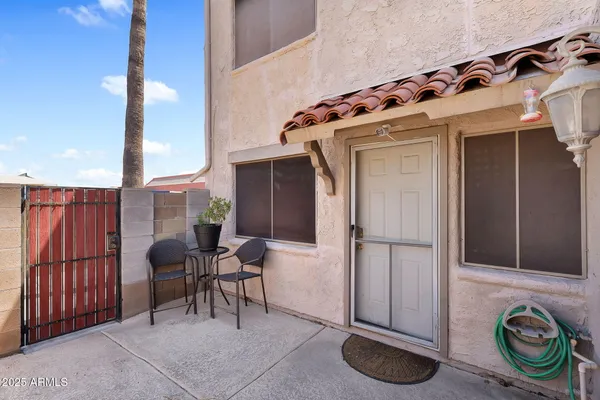 a view of a chairs and table in a patio