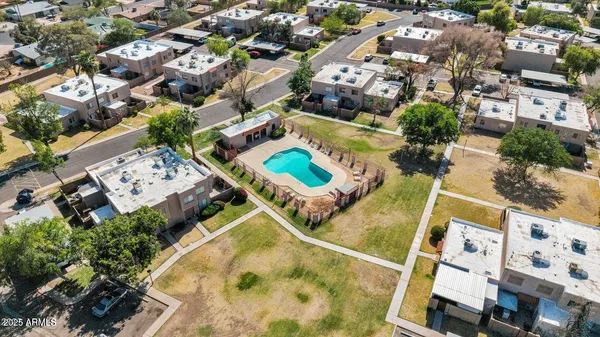 an aerial view of a house with a yard