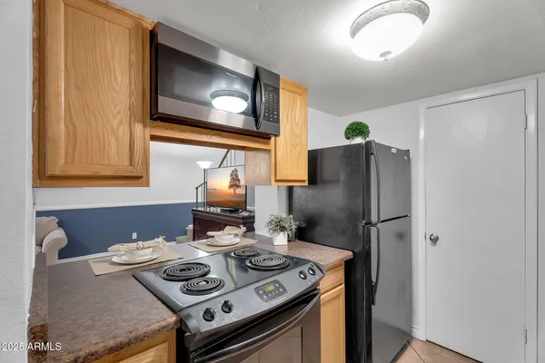 a kitchen with a stove and a refrigerator