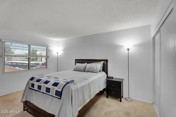 a bedroom with a bed and a window