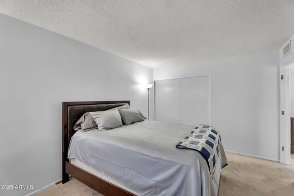 a bedroom with a bed and a night lamp