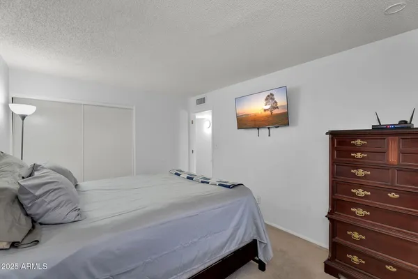 a bedroom with a bed and a television