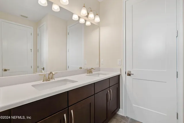 a view of a patio with dining table and chairs under an umbrella