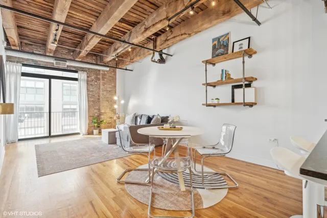 a view of a dining room with furniture wooden floor and a chandelier