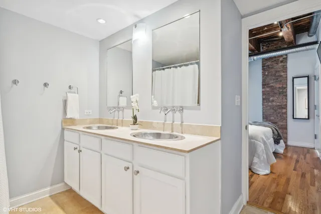 a bathroom with a double vanity sink and a mirror