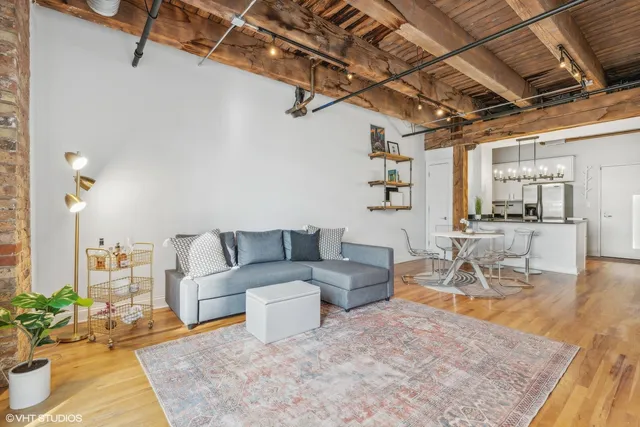a living room with furniture and a chandelier