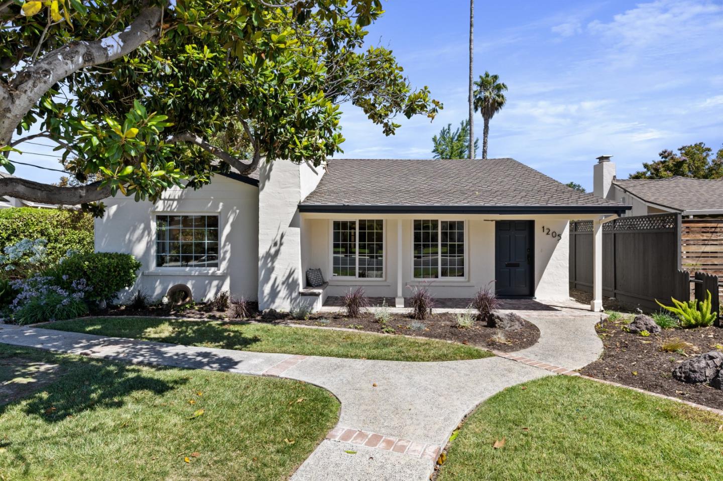 a front view of a house with garden and porch