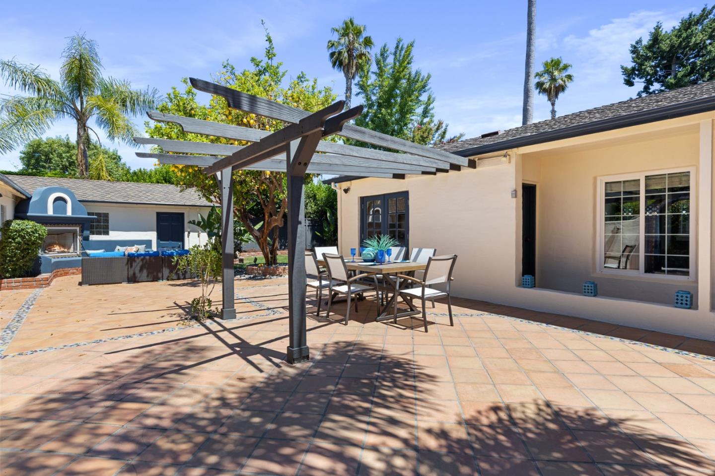 1205 Fewtrell Drive Campbell, CA 95008 - Photo 32 of 52 a view of a patio with a table and chairs under an umbrella