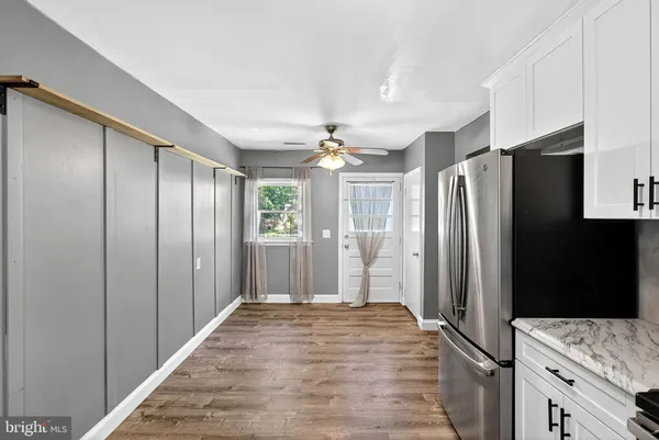 a kitchen with stainless steel appliances granite countertop a refrigerator and a sink