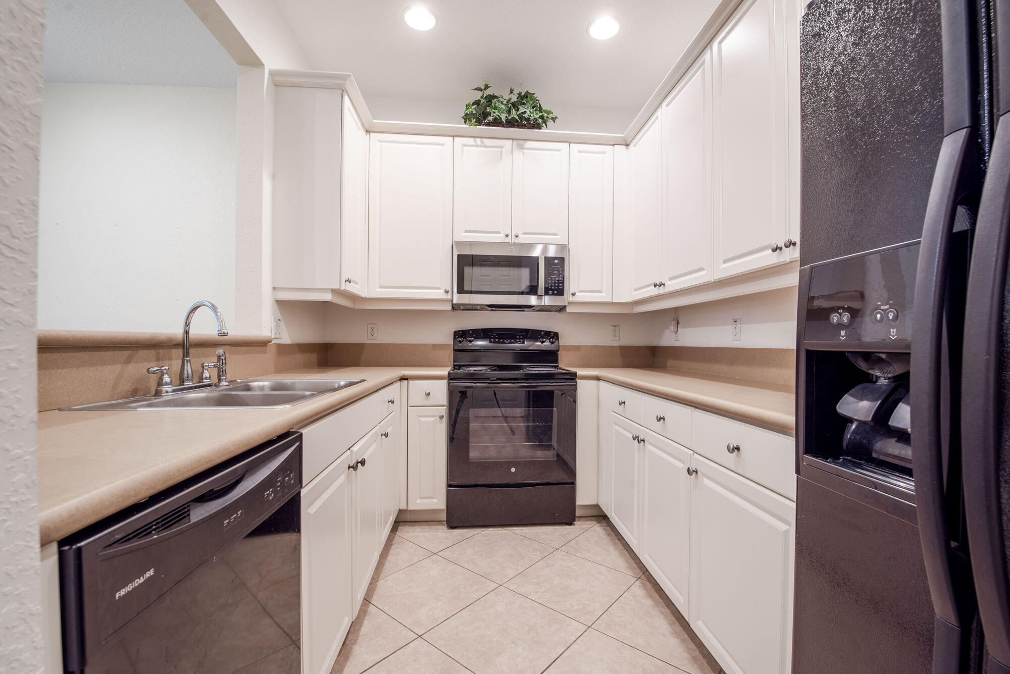 1484 Frederick Small Road Jupiter, FL 33458 - Photo 8 of 19 a kitchen with a sink stove and cabinets