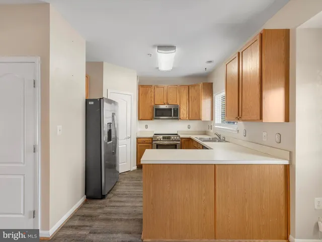 a kitchen with a sink a stove cabinets and refrigerator