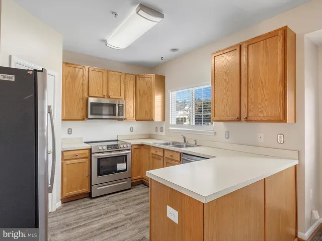 a kitchen with a sink stove and refrigerator