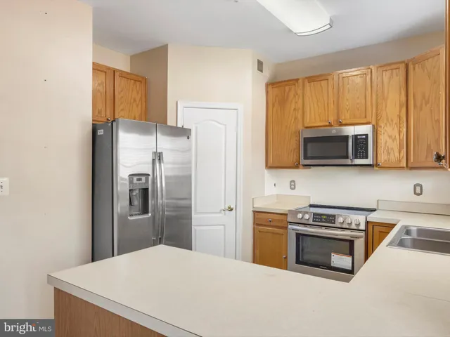 a kitchen with stainless steel appliances a stove a microwave and a refrigerator