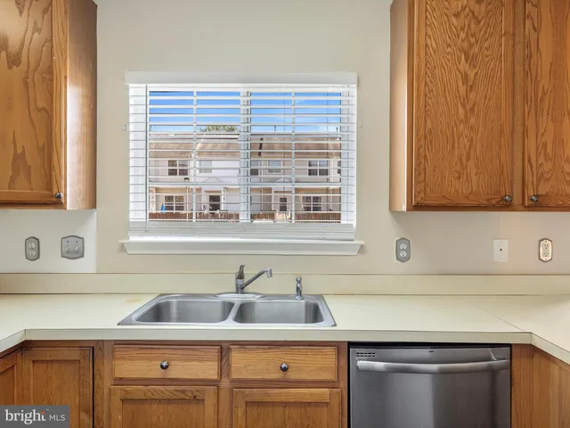 a kitchen with granite countertop cabinets sink and window