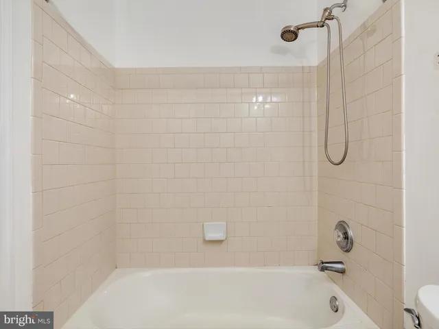 en empty room with windows and chandelier fan