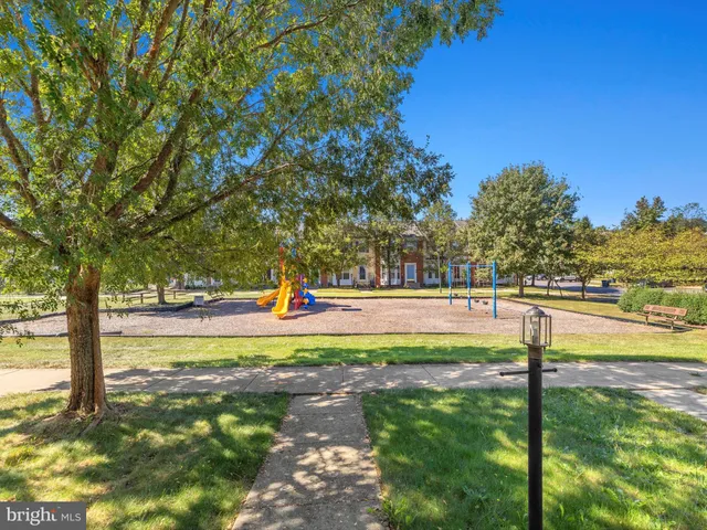 a view of yard with swimming pool and trees