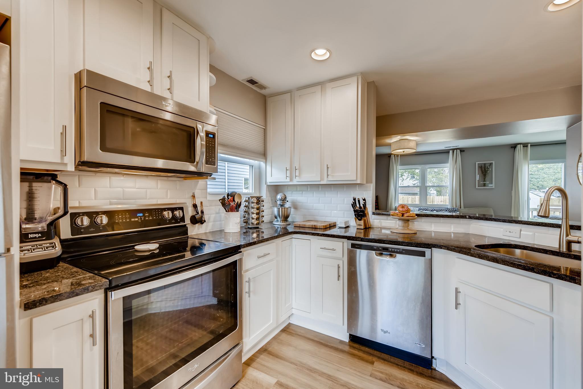 1625 Hilltop Road Edgewater, MD 21037 - Photo 11 of 38 a kitchen with a sink stove and microwave