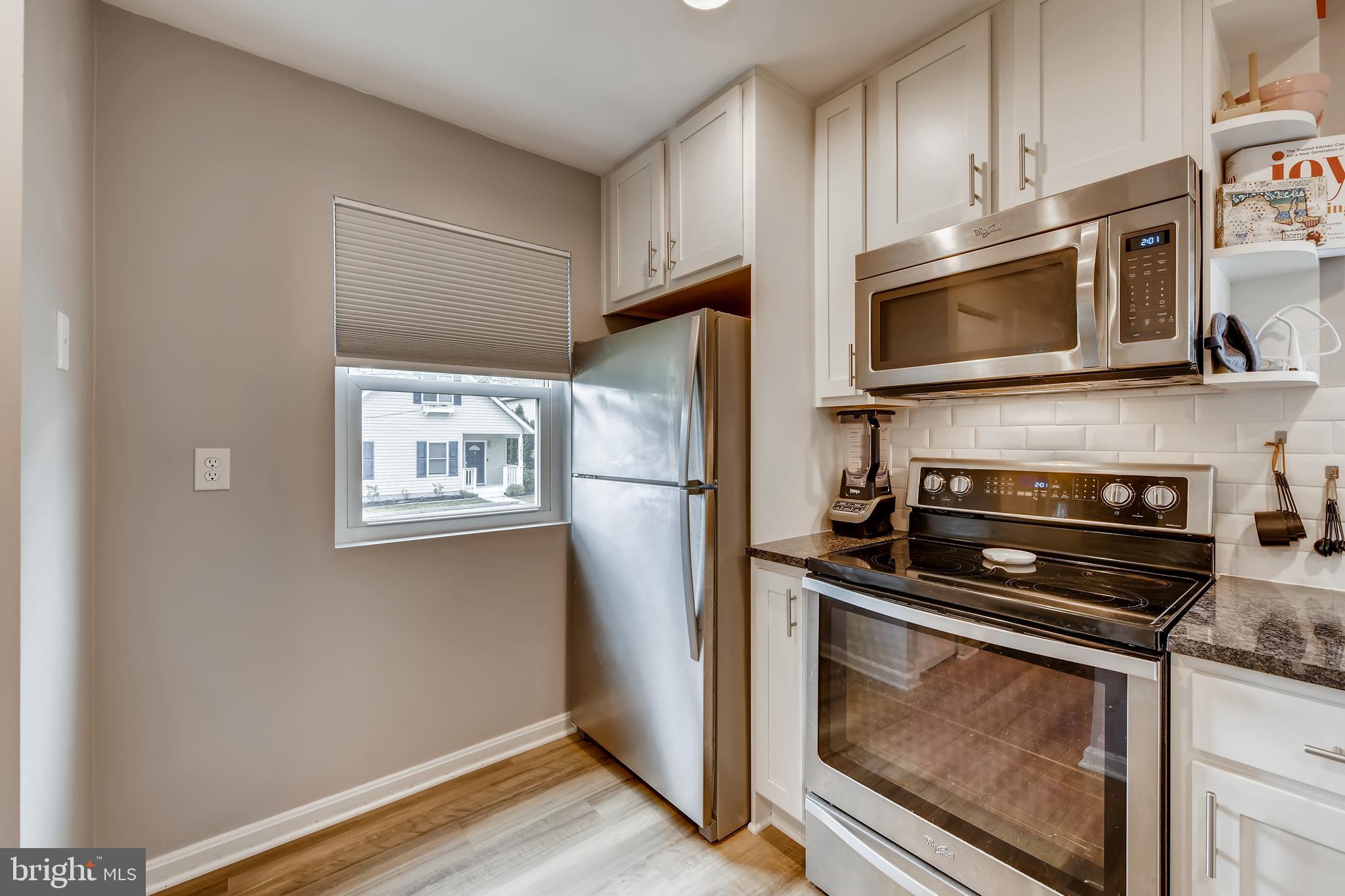 1625 Hilltop Road Edgewater, MD 21037 - Photo 12 of 38 a kitchen with stainless steel appliances a stove microwave and a refrigerator