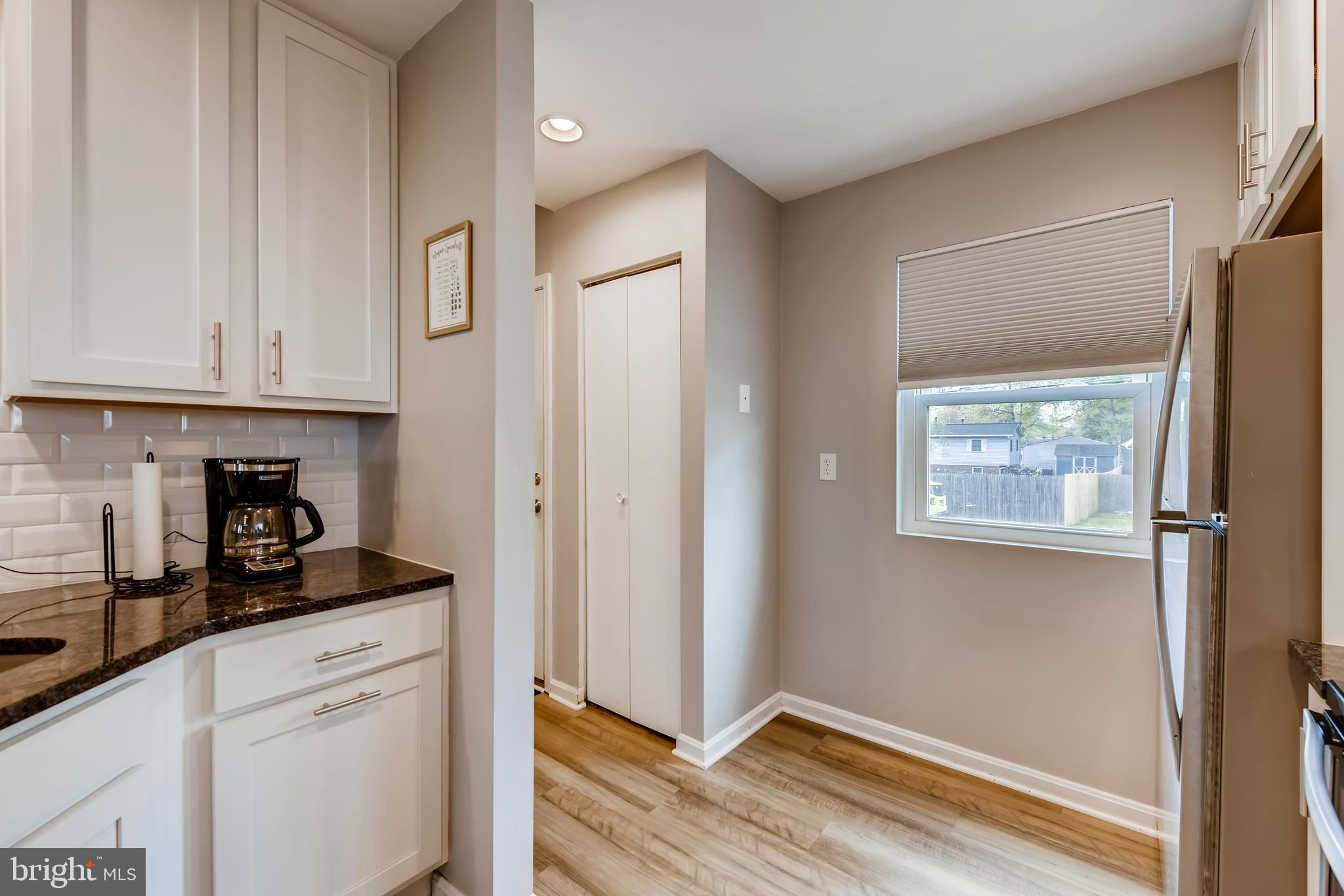 1625 Hilltop Road Edgewater, MD 21037 - Photo 14 of 38 a kitchen with stainless steel appliances white cabinets and a window