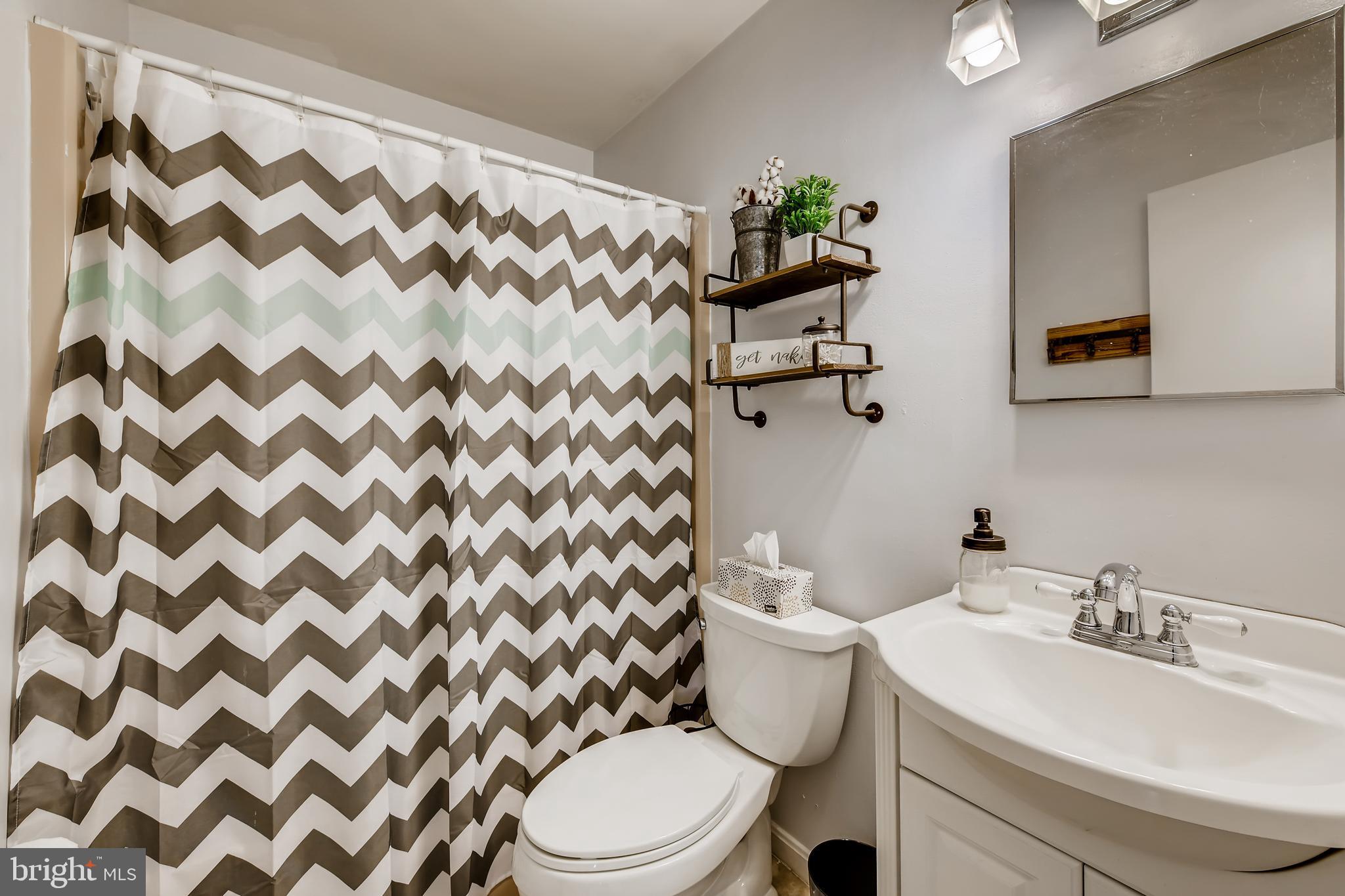 1625 Hilltop Road Edgewater, MD 21037 - Photo 20 of 38 a bathroom with a sink toilet and mirror