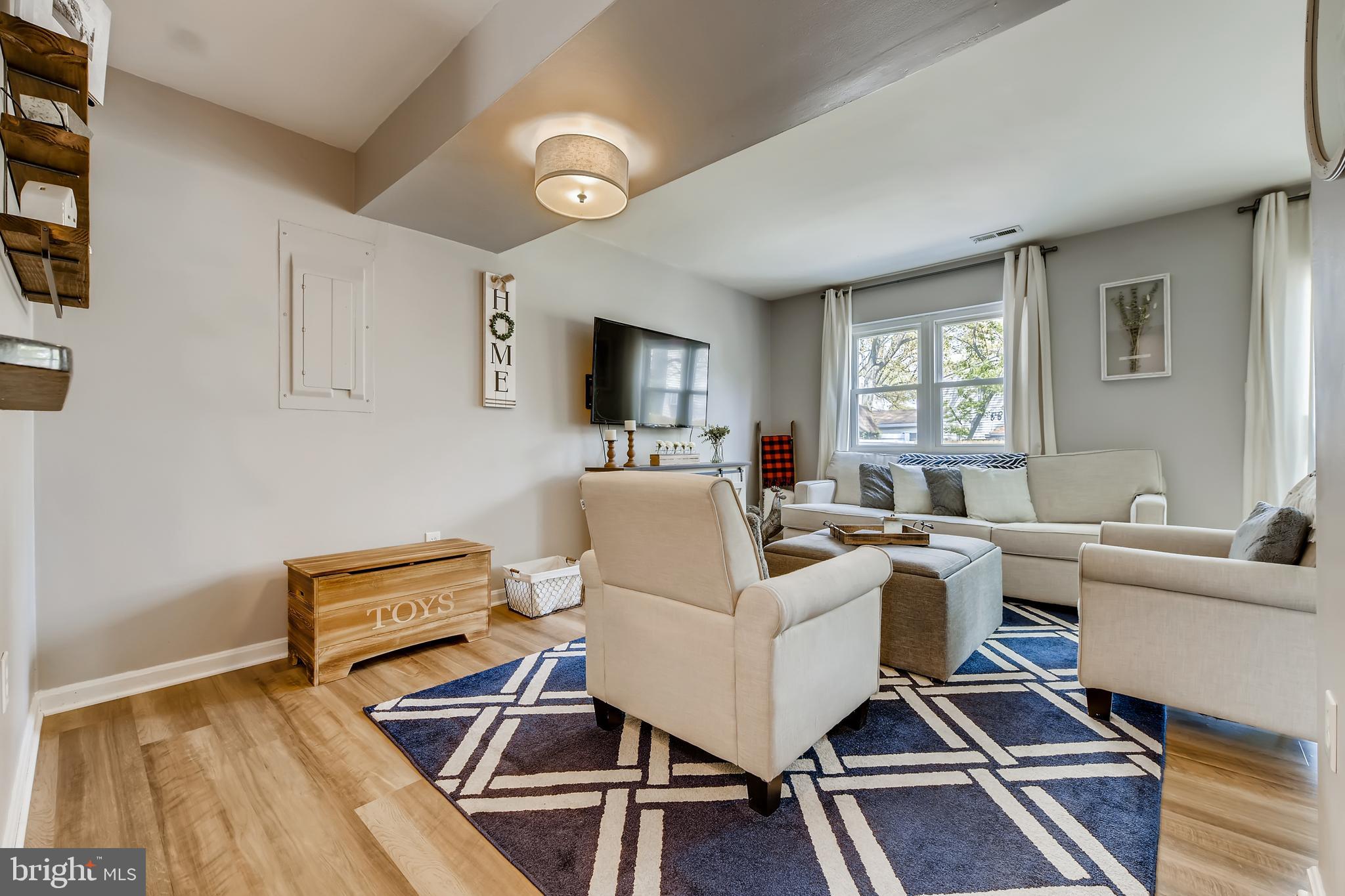 1625 Hilltop Road Edgewater, MD 21037 - Photo 7 of 38 a living room with furniture a flat screen tv and a window