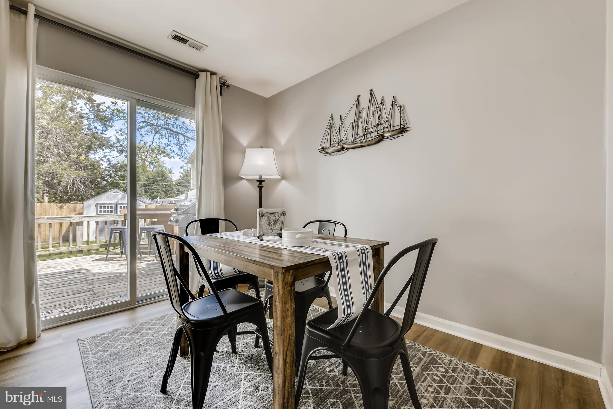 1625 Hilltop Road Edgewater, MD 21037 - Photo 9 of 38 a view of a dining room with furniture wooden floor and a carpet