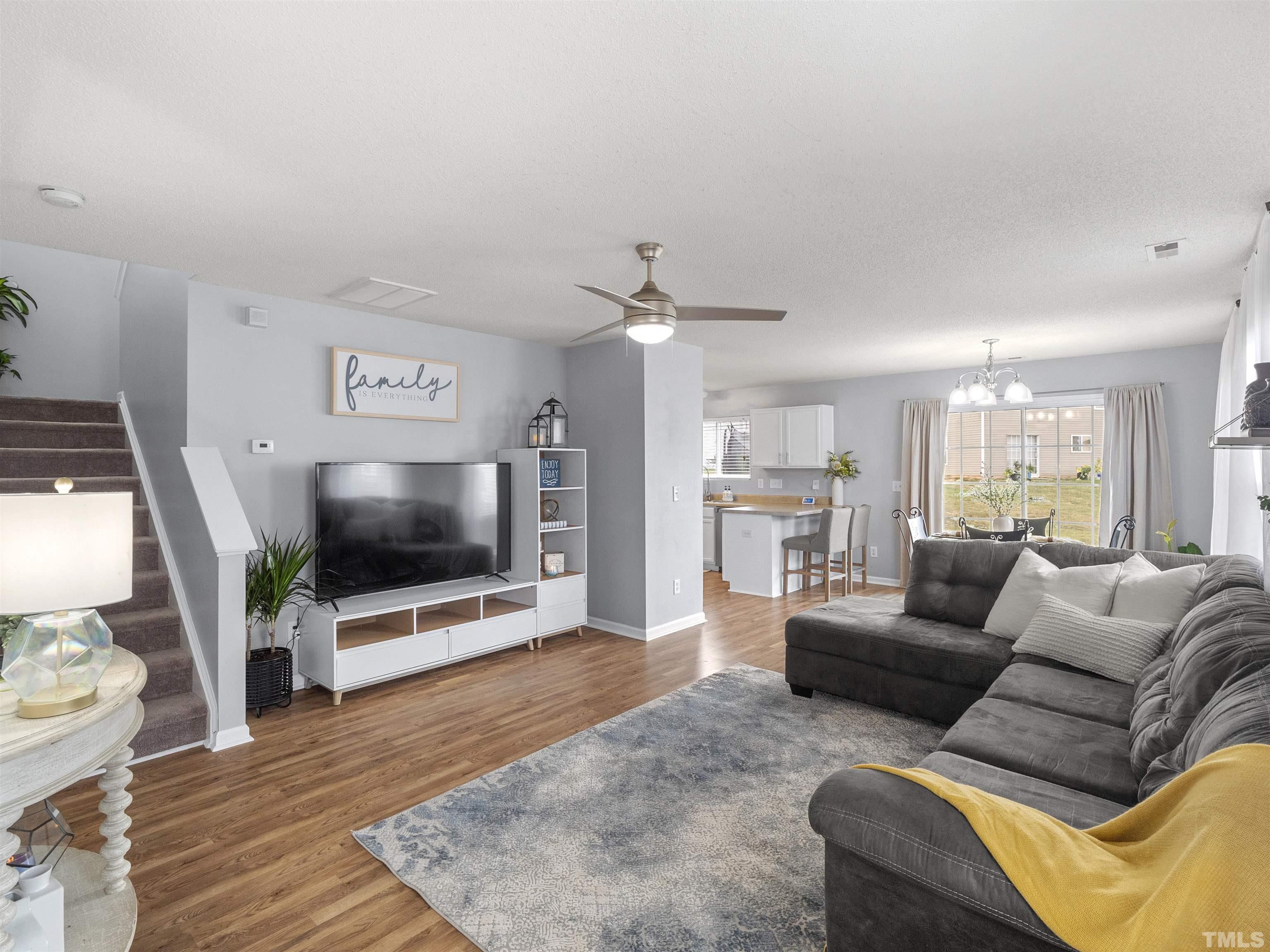 3737 Marshlane Way Raleigh, NC 27610 - Photo 2 of 26 a living room with furniture and a flat screen tv