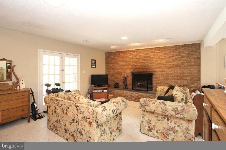15313 Good Hope Road Silver Spring, MD 20905 - Photo 3 of 10 a living room with furniture fireplace and a flat screen tv