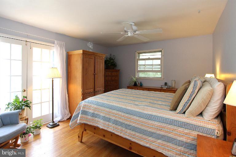 15313 Good Hope Road Silver Spring, MD 20905 - Photo 4 of 10 a bedroom with bed and wooden floor