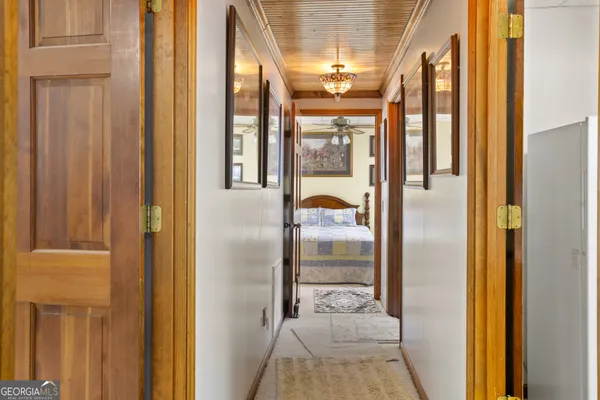 a bedroom with a large bed and a chandelier