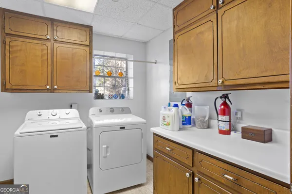 a kitchen with stainless steel appliances granite countertop a sink and wooden cabinets