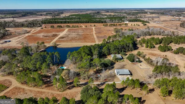 an aerial view of a house with a yard and lake view