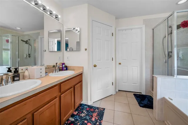 a bathroom with a double vanity sink a mirror and a shower