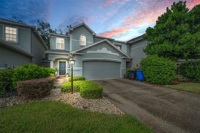 a front view of a house with a yard and garage