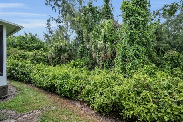 a bedroom with a bed and a lamp on dresser