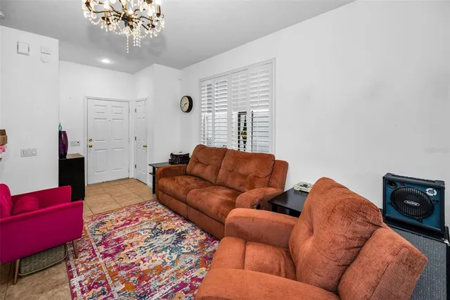 a living room with furniture and a chandelier