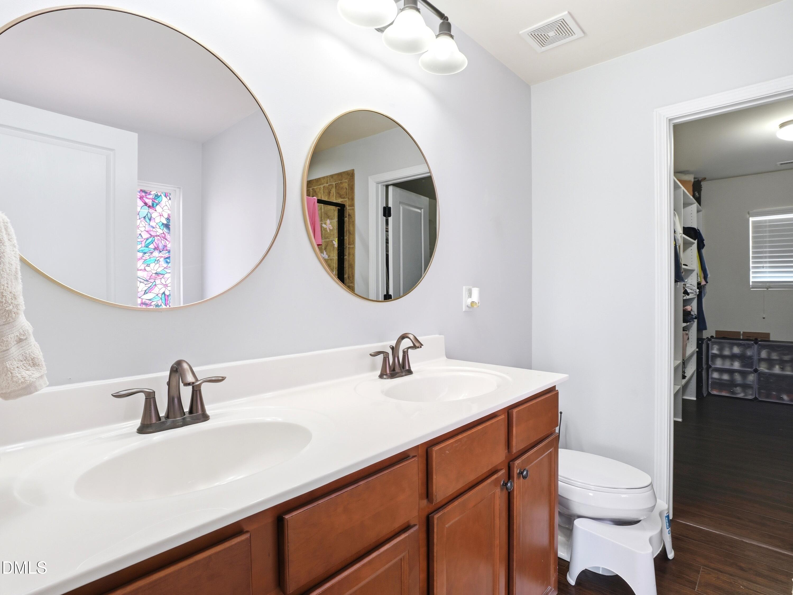 8128 Hovingham Way Raleigh, NC 27616 - Photo 19 of 40 a bathroom with a sink and a mirror