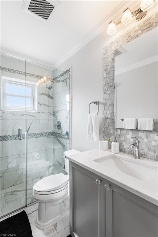 940 3rd Street South, Unit 201 Naples, FL 34102 - Photo 12 of 27 a bathroom with a sink a toilet and shower