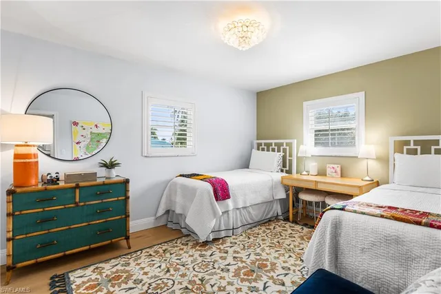 a bedroom with a bed dresser and a window