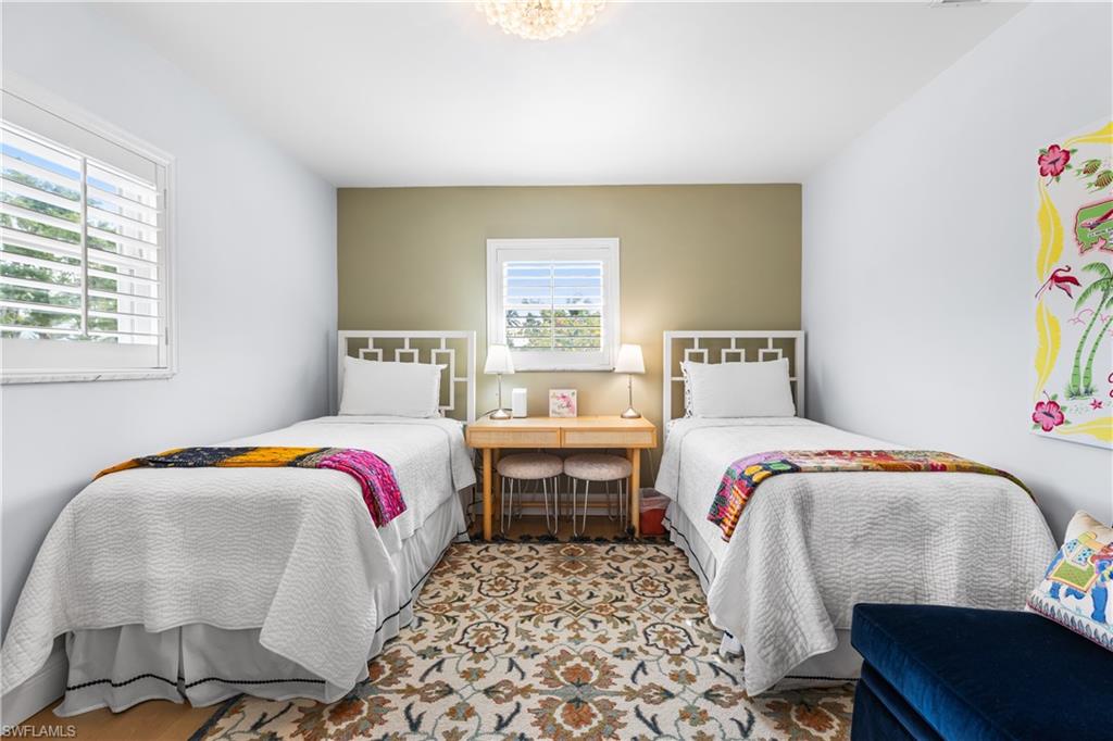 940 3rd Street South, Unit 201 Naples, FL 34102 - Photo 14 of 27 a bedroom with a bed and wooden floor