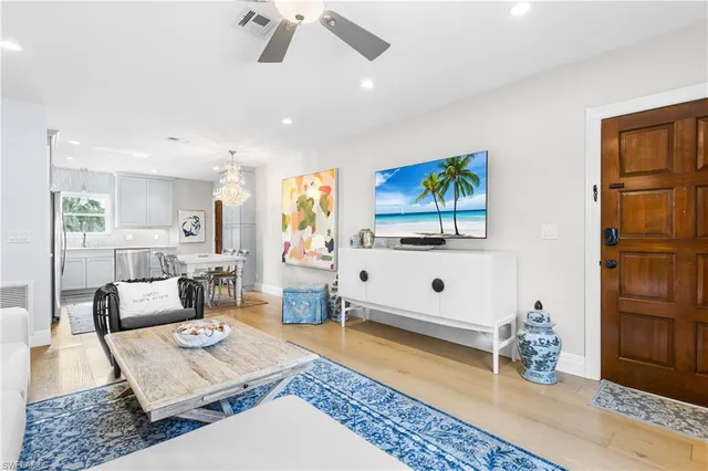 a living room with patio furniture and a flat screen tv
