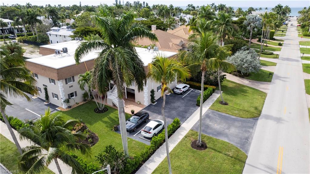 940 3rd Street South, Unit 201 Naples, FL 34102 - Photo 25 of 27 an aerial view of a house with a garden and swimming pool