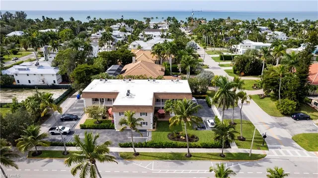 an aerial view of a house with a yard and lake view
