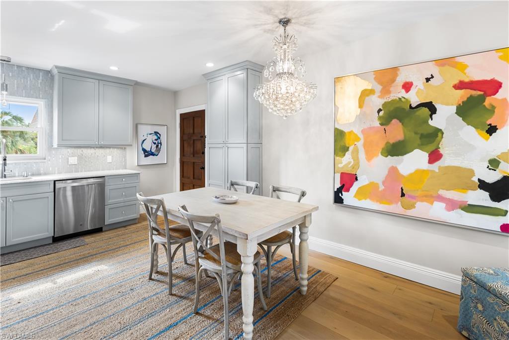 940 3rd Street South, Unit 201 Naples, FL 34102 - Photo 7 of 27 a view of a dining room with furniture and chandelier