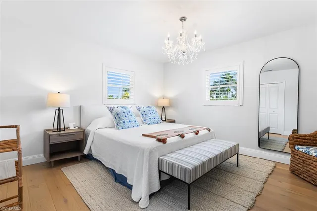 a bedroom with bed and a chandelier