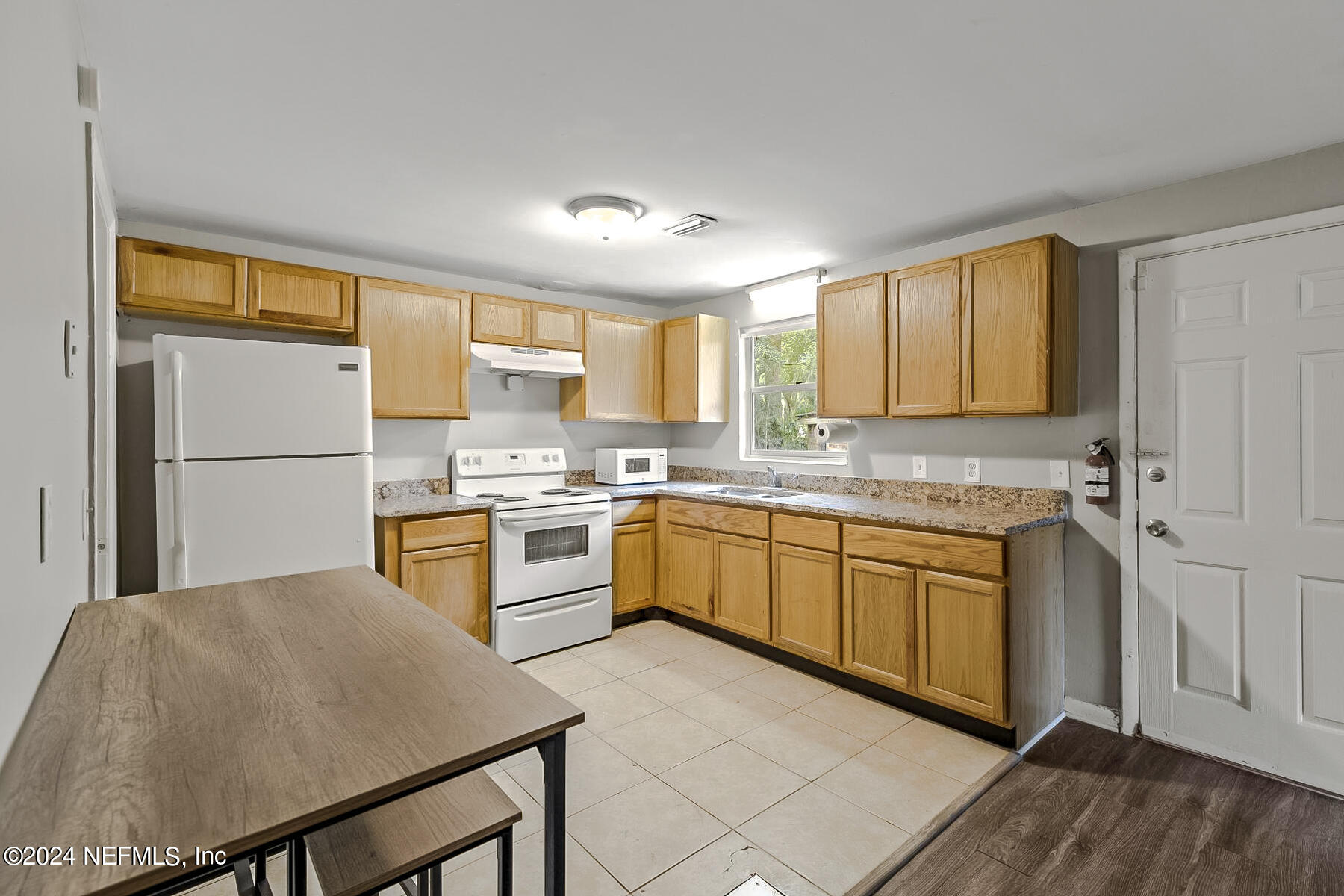 a kitchen with granite countertop a sink appliances cabinets and counter space